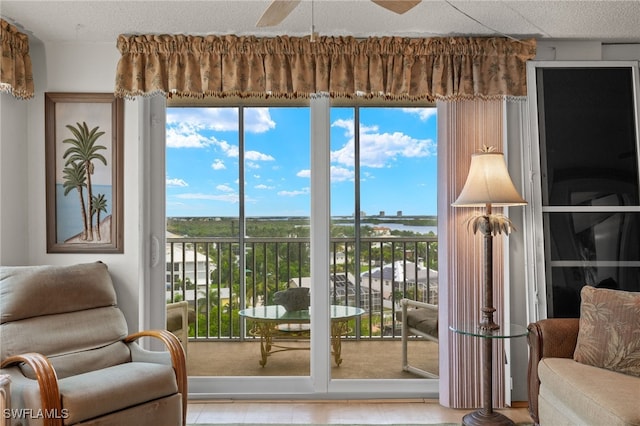 doorway to outside with a textured ceiling and a ceiling fan