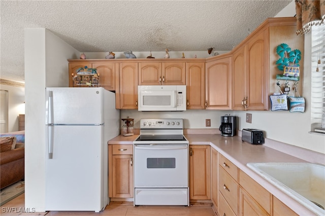 kitchen featuring white appliances, sink, a textured ceiling, and light brown cabinets