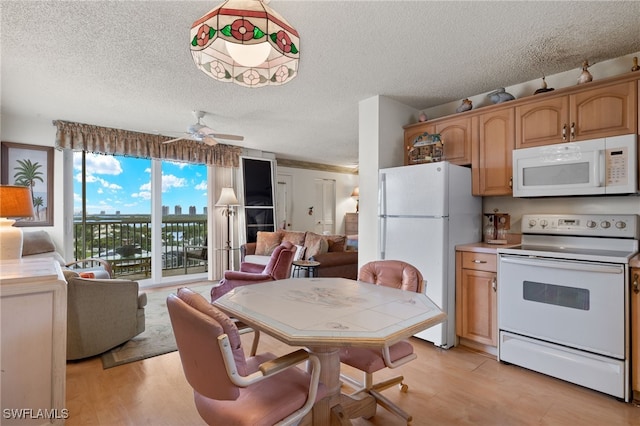 kitchen with white appliances, light hardwood / wood-style flooring, a textured ceiling, track lighting, and ceiling fan