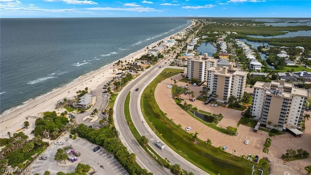 drone / aerial view featuring a water view and a view of the beach