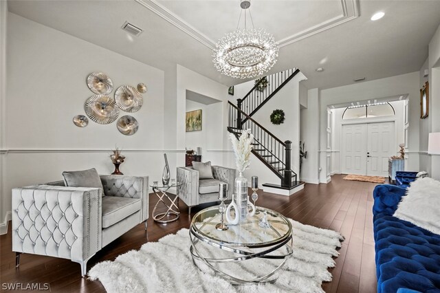 living room with dark hardwood / wood-style floors and an inviting chandelier