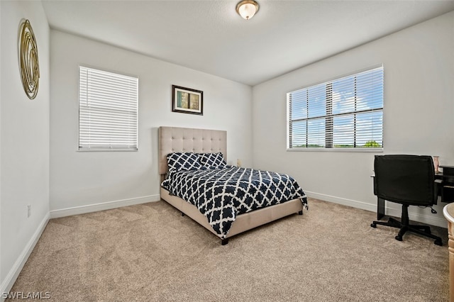 bedroom featuring light carpet