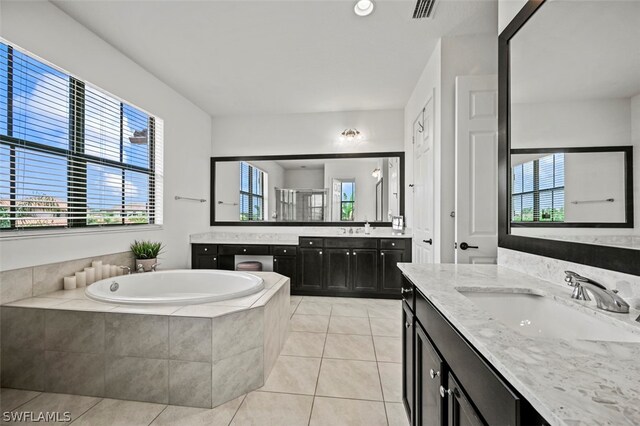 bathroom with tile patterned floors, vanity, and independent shower and bath