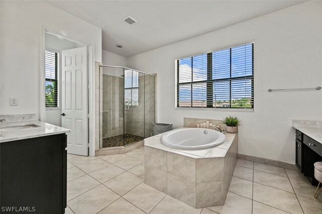 bathroom with tile patterned flooring, vanity, and independent shower and bath