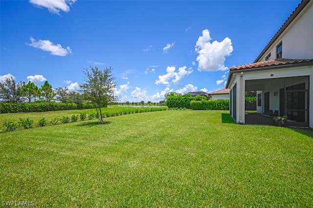 view of yard featuring a rural view and a sunroom