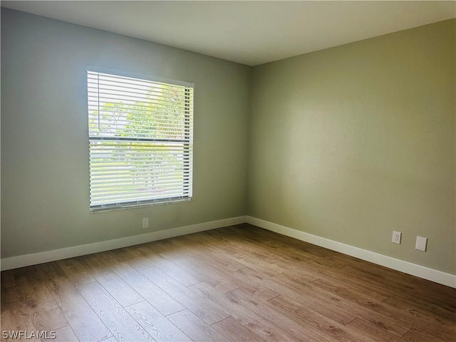 unfurnished room with light wood-type flooring