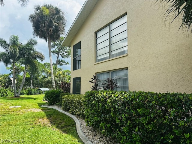 view of property exterior with a lawn