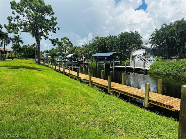 dock area featuring a water view and a yard