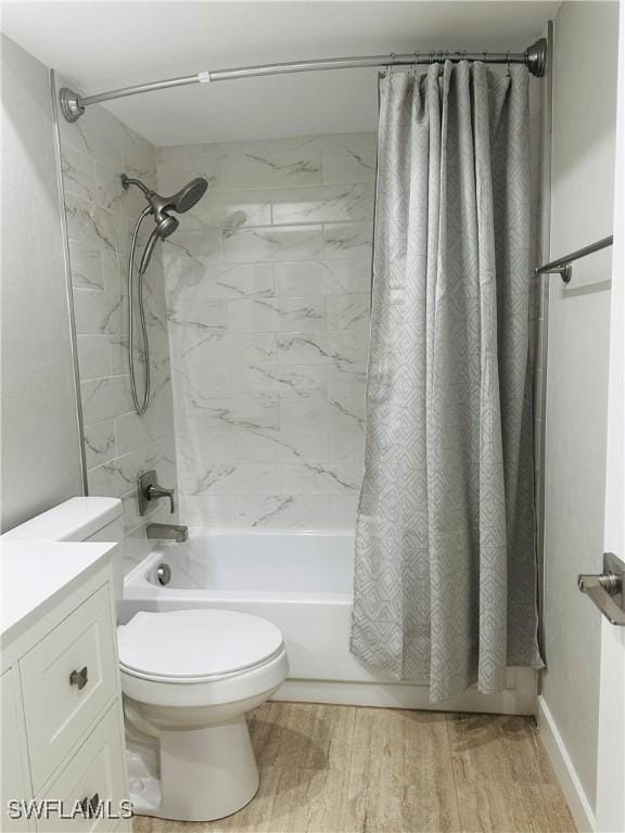 full bathroom featuring toilet, vanity, shower / bathtub combination with curtain, and hardwood / wood-style floors