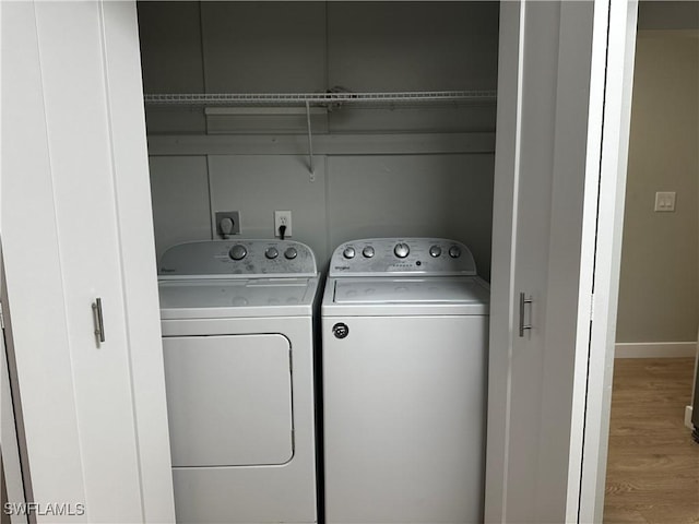 clothes washing area featuring hardwood / wood-style floors and independent washer and dryer