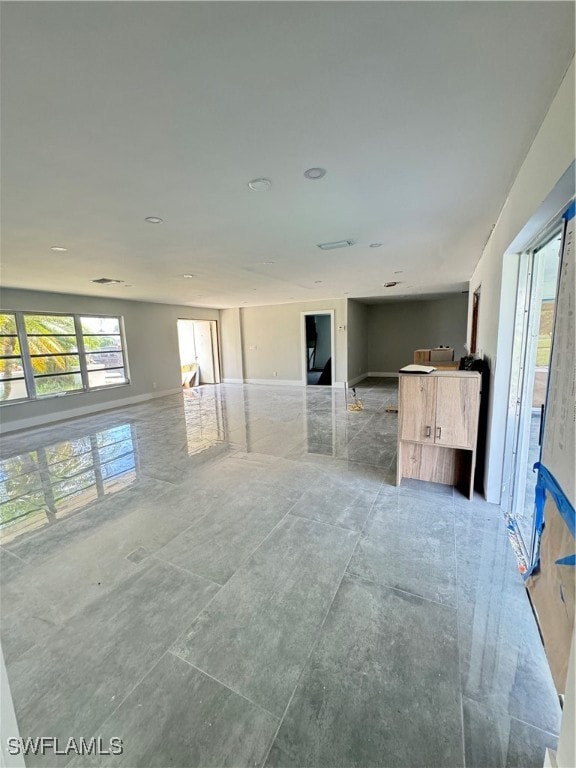 unfurnished living room with tile patterned floors