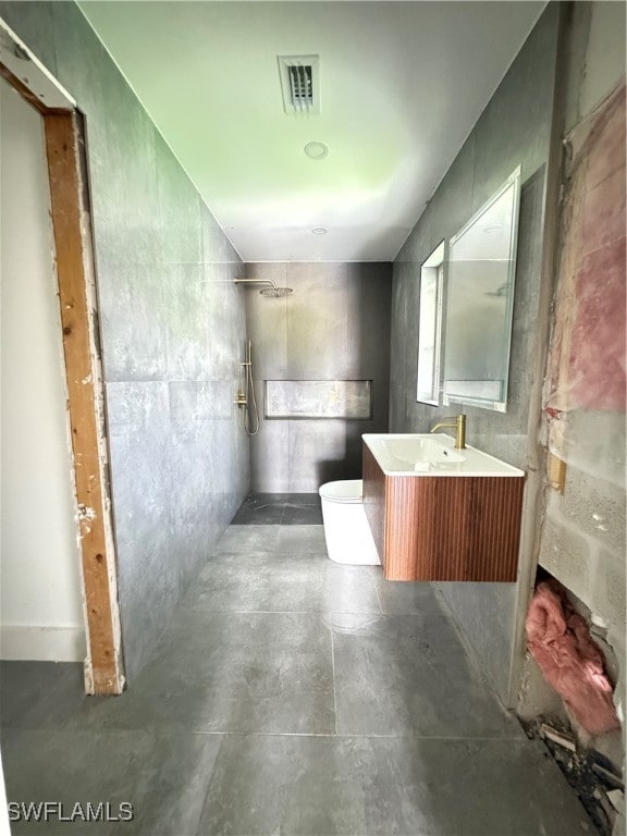 bathroom with vanity, tile patterned floors, walk in shower, and toilet