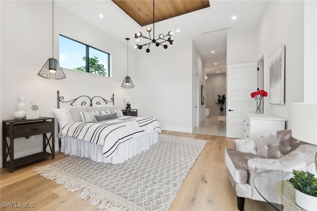 bedroom featuring a notable chandelier and light hardwood / wood-style floors