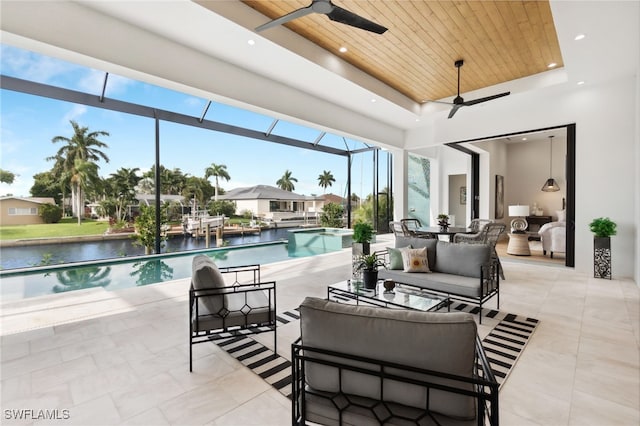 view of swimming pool featuring ceiling fan and a water view