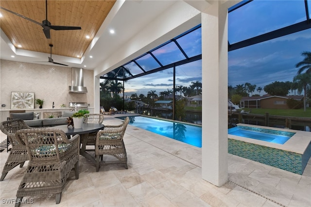 pool at dusk featuring ceiling fan and a grill