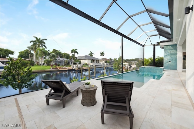 view of pool with a patio, a water view, and glass enclosure