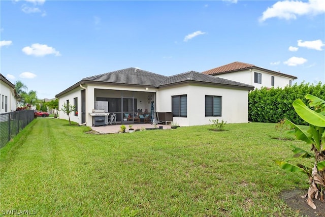 back of house with a yard and a patio area