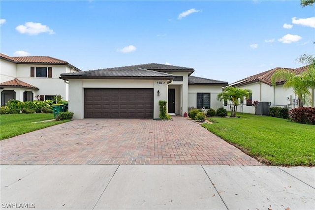 view of front of house featuring a garage and a front lawn