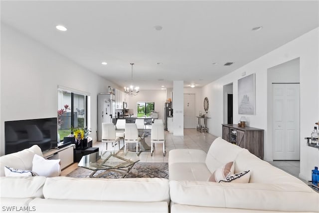 living room with light tile patterned flooring and a chandelier