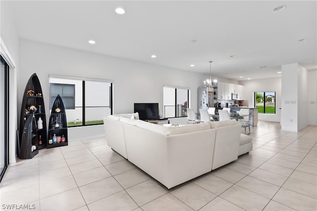 living room featuring light tile patterned floors and a chandelier