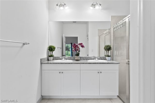 bathroom featuring vanity, tile patterned floors, and a shower with shower door