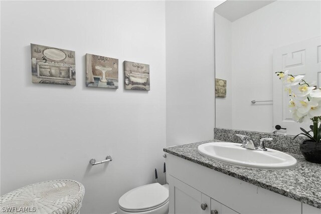 bathroom with vanity and toilet