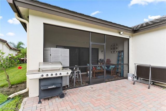 view of patio / terrace featuring grilling area and a sunroom