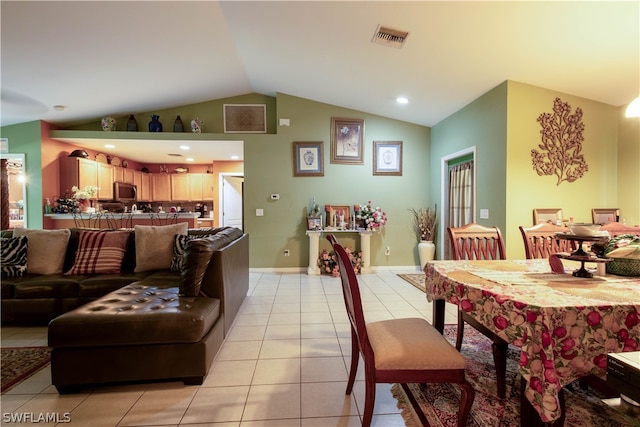 tiled dining space with vaulted ceiling