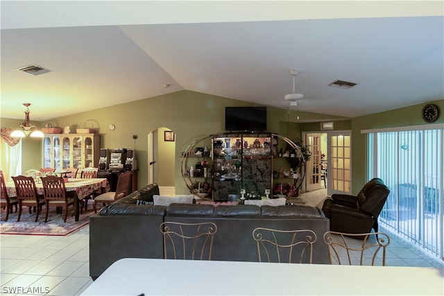 living room with light tile patterned flooring, french doors, and lofted ceiling