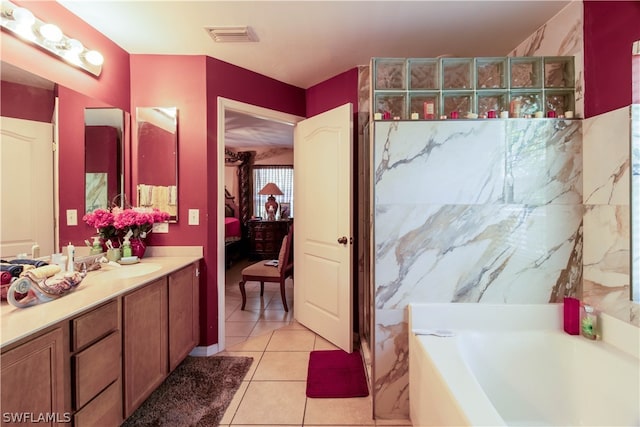 bathroom featuring vanity, a tub to relax in, and tile patterned floors