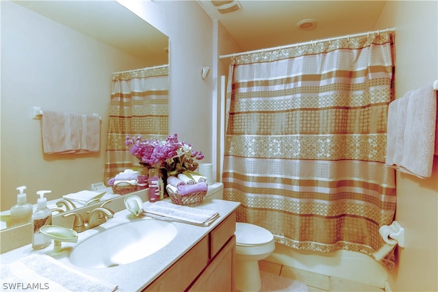 bathroom featuring tile patterned flooring, toilet, and vanity