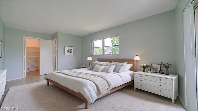 bedroom featuring a walk in closet and a closet