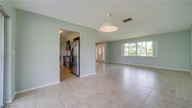 empty room with light tile patterned floors