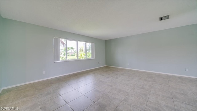 spare room with light tile patterned floors