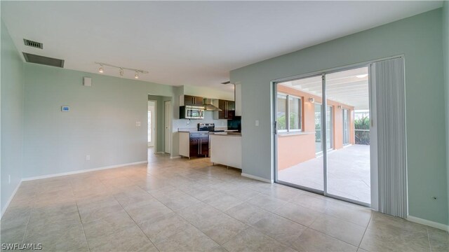 unfurnished living room featuring light tile patterned floors