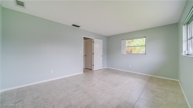 spare room featuring light tile patterned flooring