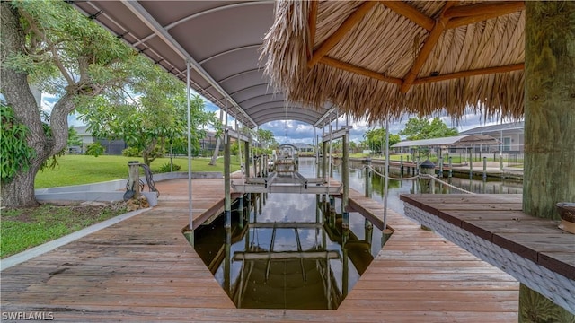 view of dock with a water view and a yard