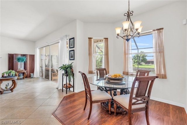 tiled dining space featuring an inviting chandelier