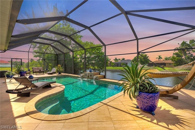 outdoor pool featuring glass enclosure and a patio