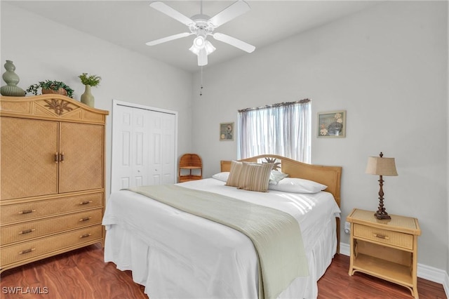 bedroom with dark hardwood / wood-style flooring, a closet, and ceiling fan