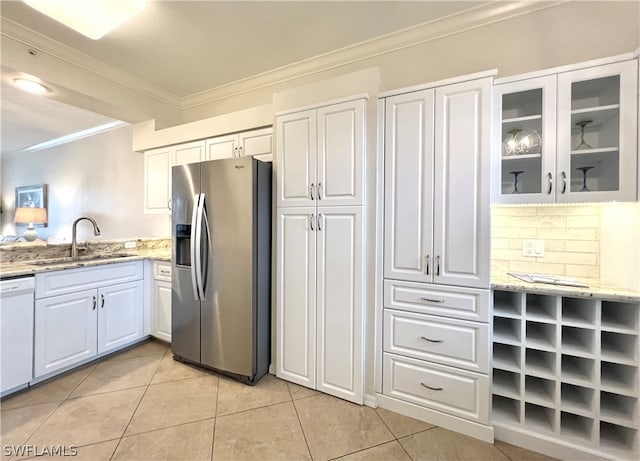 kitchen with light stone counters, white cabinets, and stainless steel fridge with ice dispenser