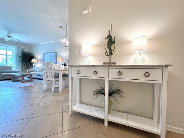 details featuring tile patterned flooring and ceiling fan with notable chandelier