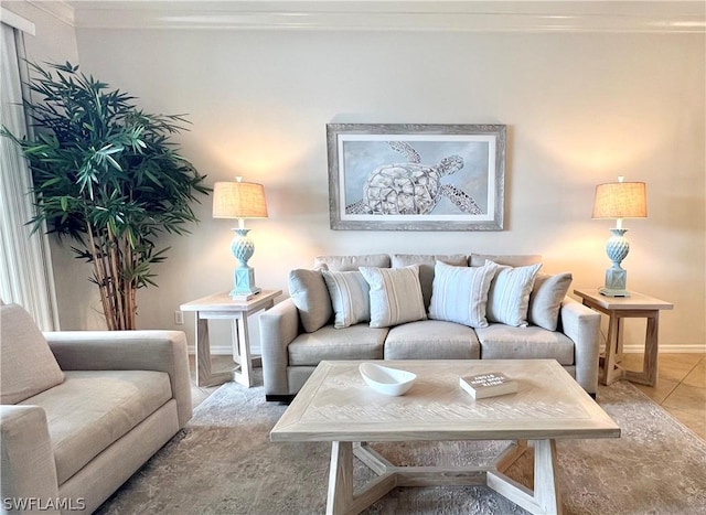 living room with baseboards, tile patterned floors, and crown molding