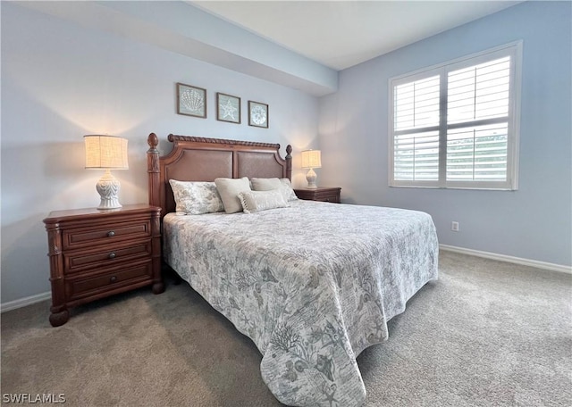 carpeted bedroom featuring baseboards