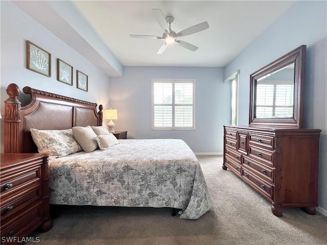 bedroom featuring a ceiling fan, light carpet, and baseboards