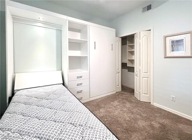 carpeted bedroom featuring baseboards and visible vents