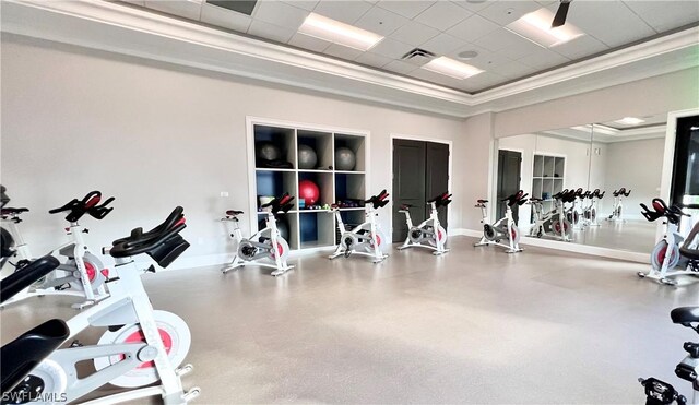 workout area featuring a raised ceiling and a paneled ceiling