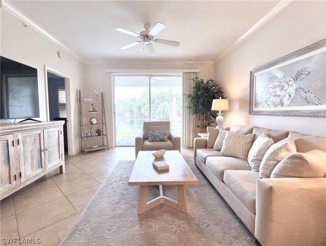 living room featuring ornamental molding, light tile patterned floors, and ceiling fan