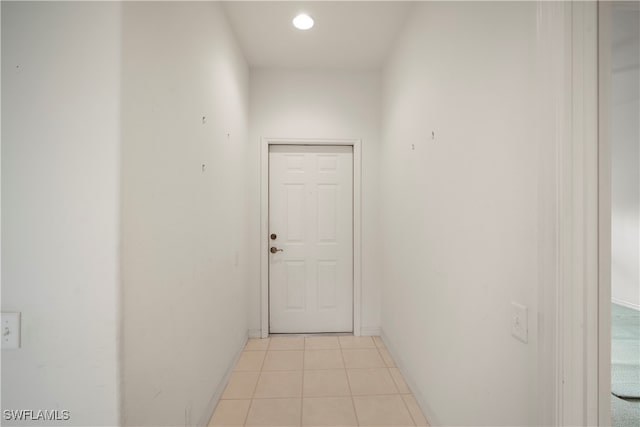 hall with light tile patterned floors