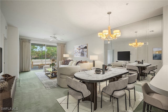 carpeted dining space with ceiling fan with notable chandelier